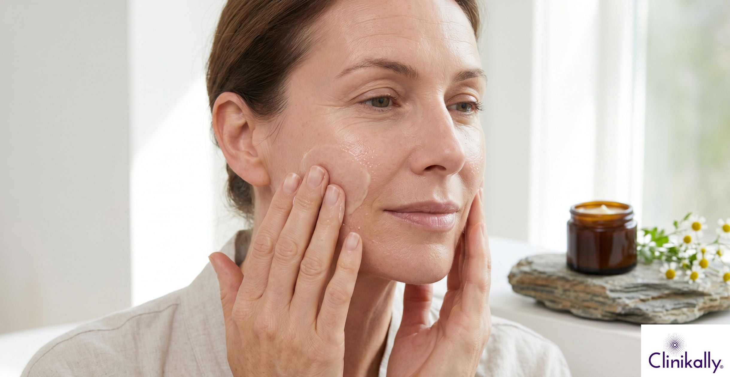 Woman applying anti aging cream on face
